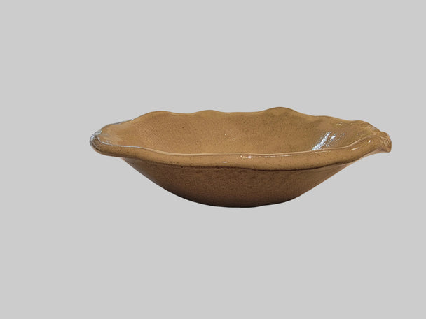 Small ceramic salad bowl with a blurred white background.
