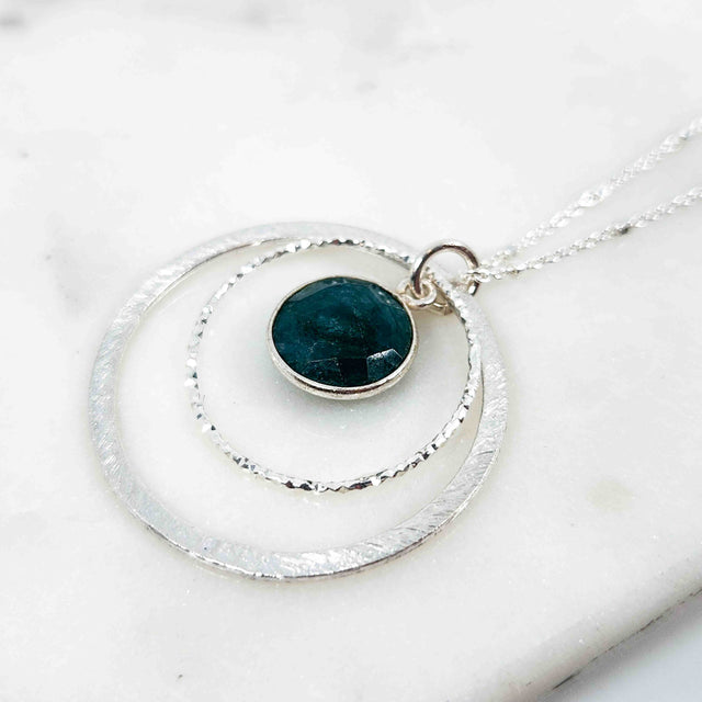 Round Shaped Emerald Surrounded by Double Circle Necklace