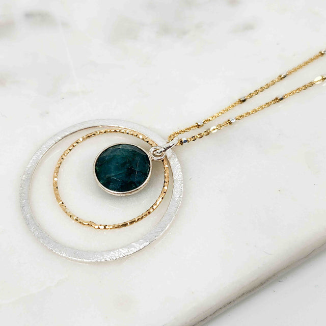 Round Shaped Dangling Emerald Surrounded by Double Circle Necklace