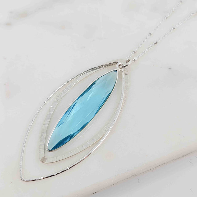 Long Marquise Shaped Blue Topaz Surrounded by Textured Double Petal Necklace