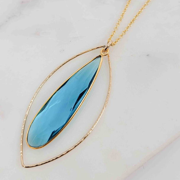 Teardrop Shaped Blue Topaz Surrounded by Textured Round Wire Open Petal Necklace