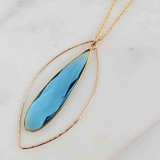 Teardrop Shaped Blue Topaz Surrounded by Textured Round Wire Open Petal Necklace