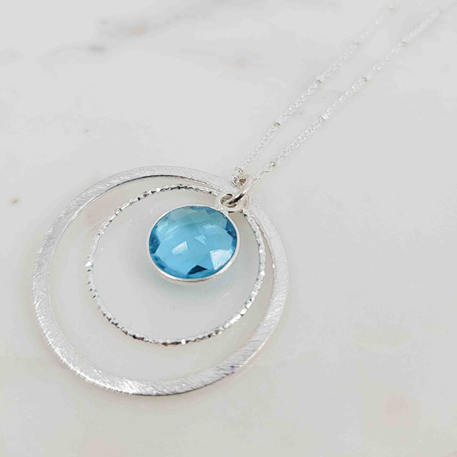 Round Shaped Dangling Blue Topaz Surrounded by Double Circles Necklace