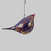 Decorative glass bird blue with red and gold on a white background