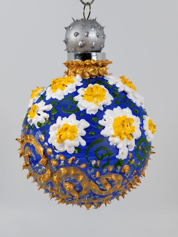Hand painted ornament with blue back ground, white daisies and gold swirls and silver accents