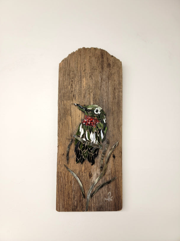 Glass mosaic of a hummingbird on a reclaimed barn wood panel.